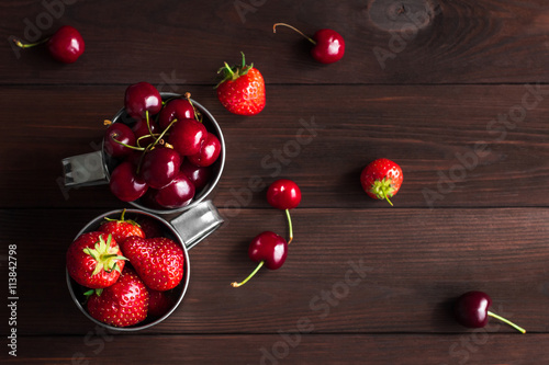 Photos Strawberry and sweet cherry on wooden background, top view, flat lay