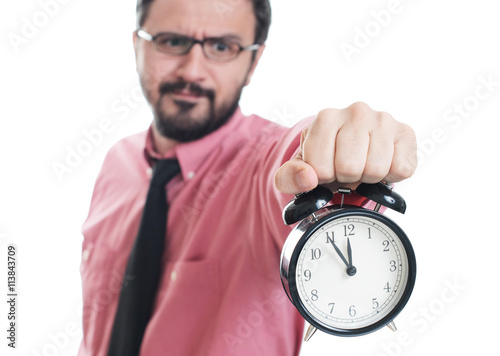 Young man showing an alarm clock