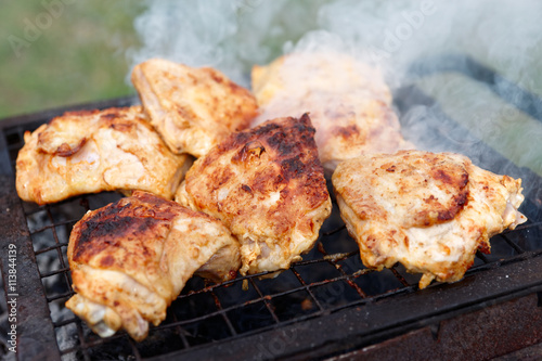 Chicken legs being fried on grill