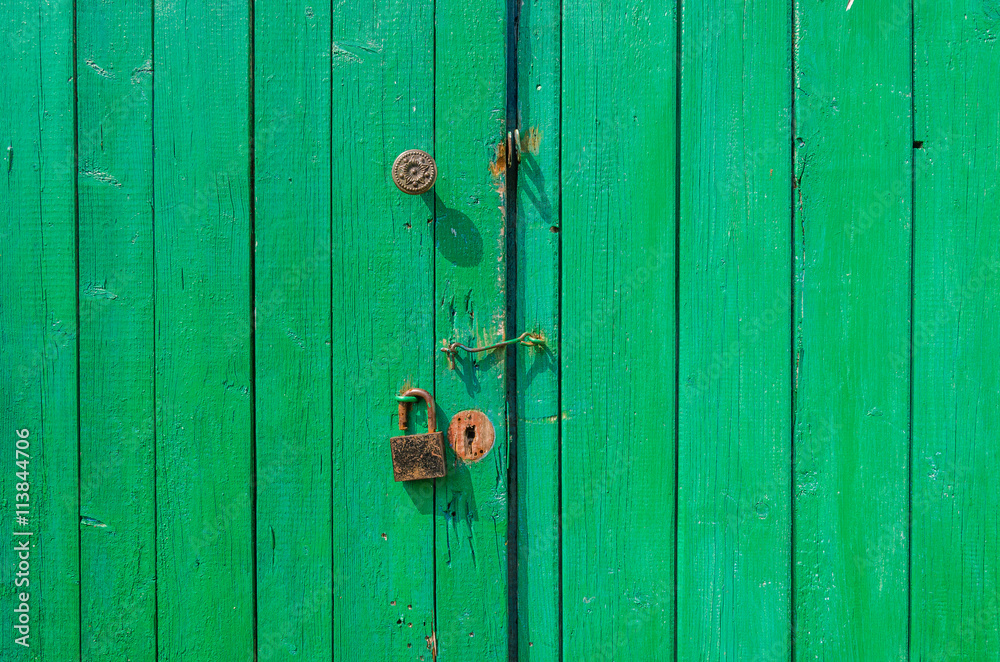 green old wooden gate/green wooden gate with a padlock and the handle green old wooden gate/green wooden gate with a padlock and the handle