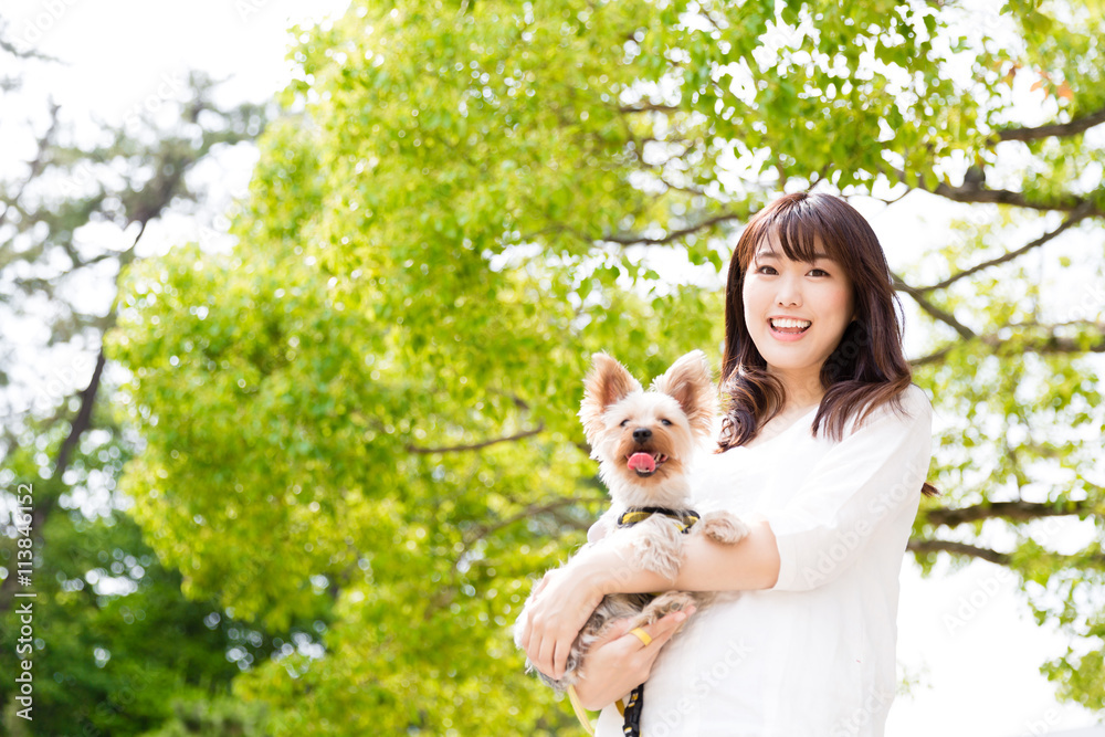 portrait of young asian woman with dog in the park portrait of young asian woman with dog in the park