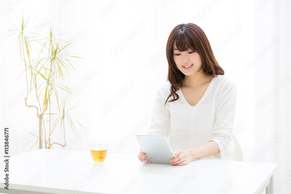 attractive asian woman using tablet computer attractive asian woman using tablet computer