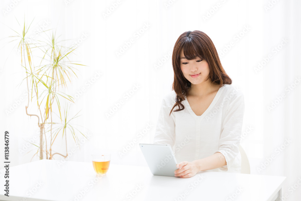 attractive asian woman using tablet computer attractive asian woman using tablet computer