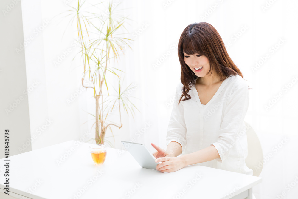 attractive asian woman using tablet computer attractive asian woman using tablet computer