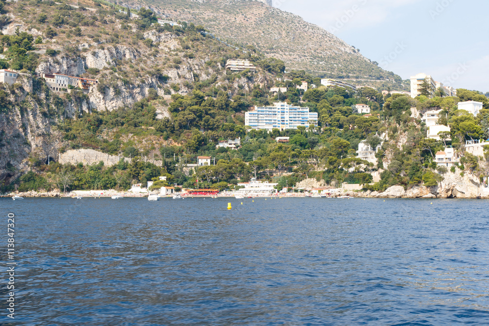 Luxury homes on the rocky Mediterranean coast of the French Riviera. Horizontal with copy space for text Luxury homes on the rocky Mediterranean coast of the French Riviera. Horizontal with copy space for text