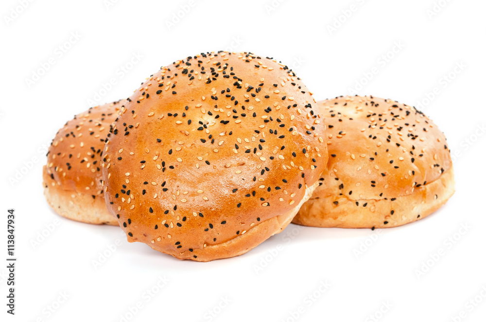 Three burger buns with sesame seeds on white background Three burger buns with sesame seeds on white background