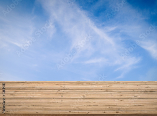 wooden counter with blue sky background