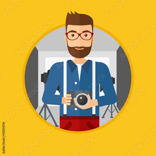 Photographer with camera in photo studio.