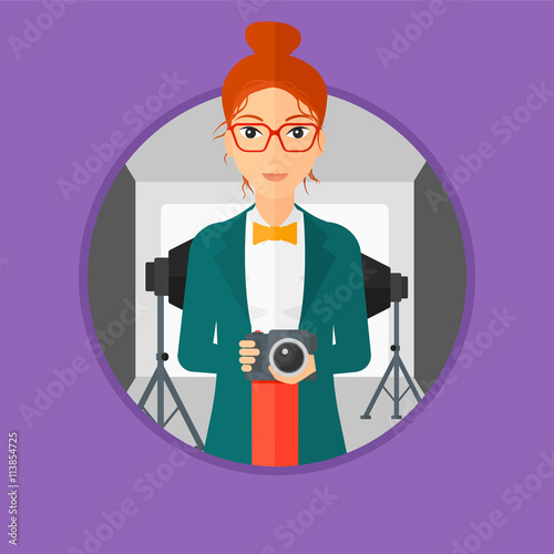 Smiling photographer holding camera.
