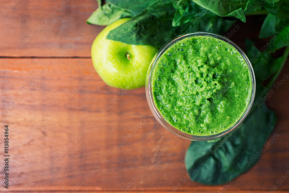 Apple - spinach healthy drink on wooden table Apple - spinach healthy drink on wooden table
