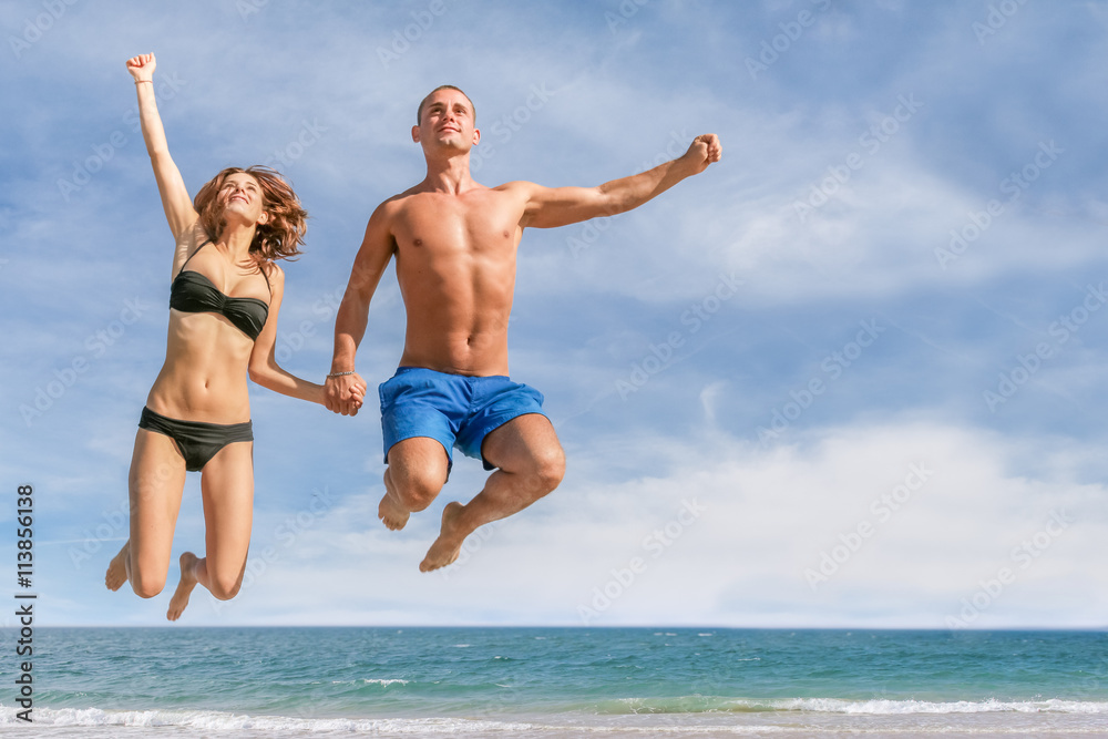 beautiful couple jump on exotic beach hand in hand on vacation beautiful couple jump on exotic beach hand in hand on vacation