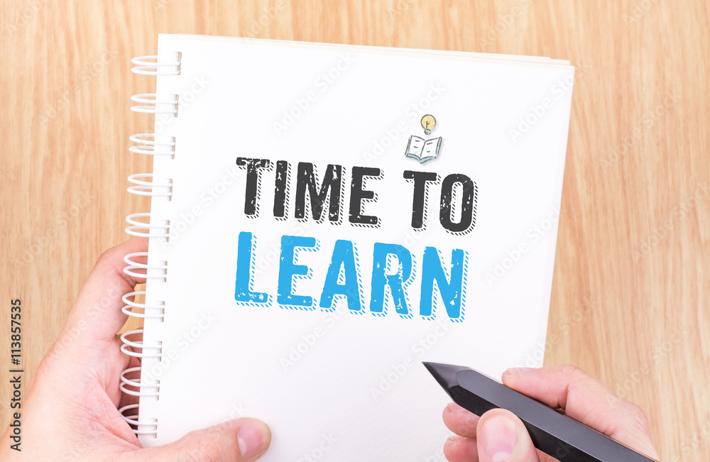 Time to learn word on white ring binder notebook with hand holdi