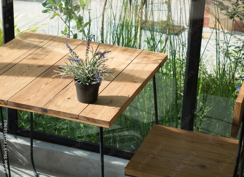 Violet lavender flowers and green leaf in flowerpot on wooden table ( twilight and evening tone color )