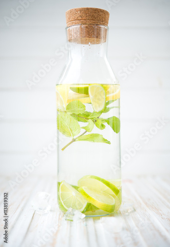 Homemade lemonade with a lime, a lemon and mint
