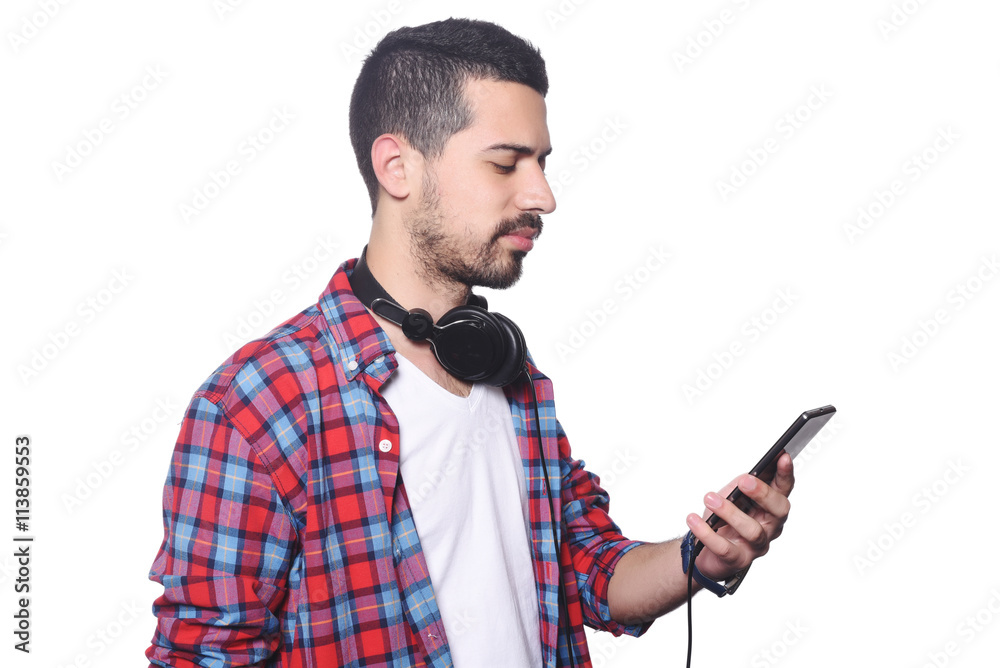 Young latin man typing on his smartphone. Young latin man typing on his smartphone.