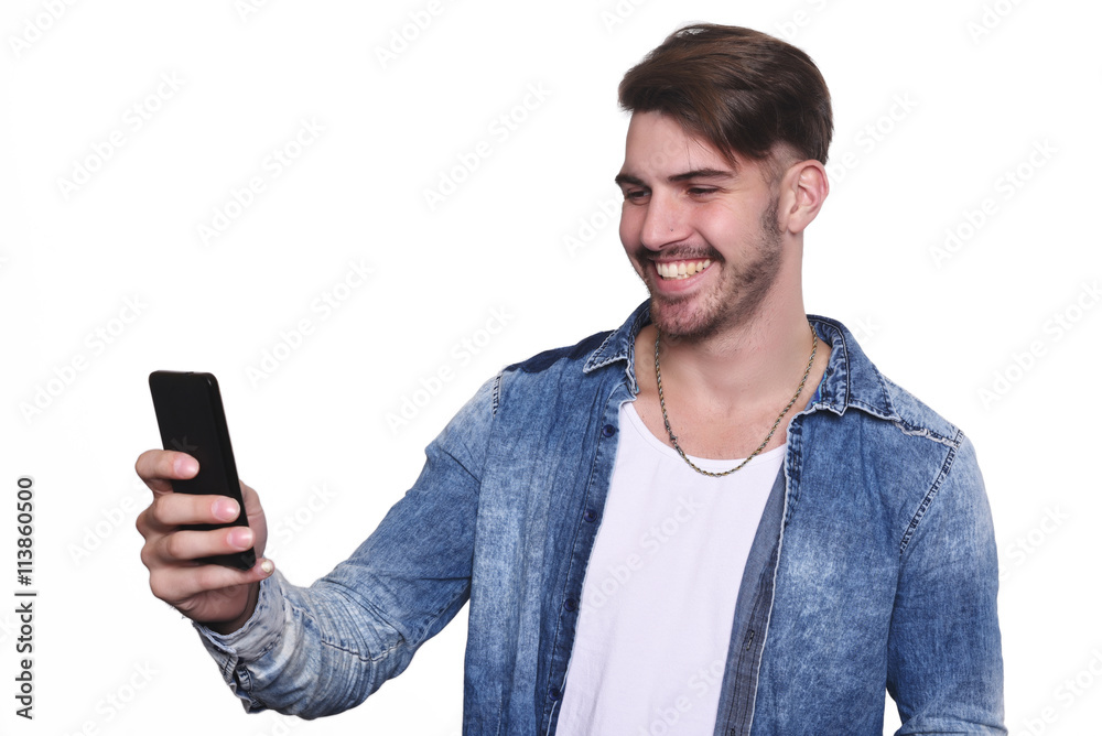 Young man taking a selfie with his smartphone Young man taking a selfie with his smartphone