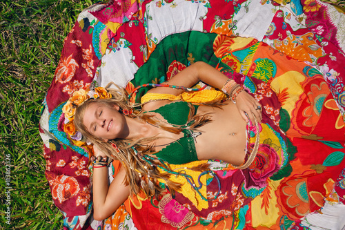 boho style woman lying on the grass
