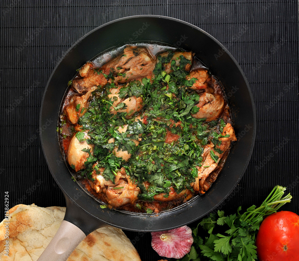 Chakhokhbili - traditional Georgian dish. Chicken stewed with he Chakhokhbili - traditional Georgian dish. Chicken stewed with he