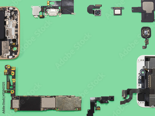 Flat lay (top view) of smart phone components isolate on green background with copy space 