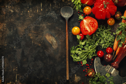 Wooden spoon and ingredients on dark background
