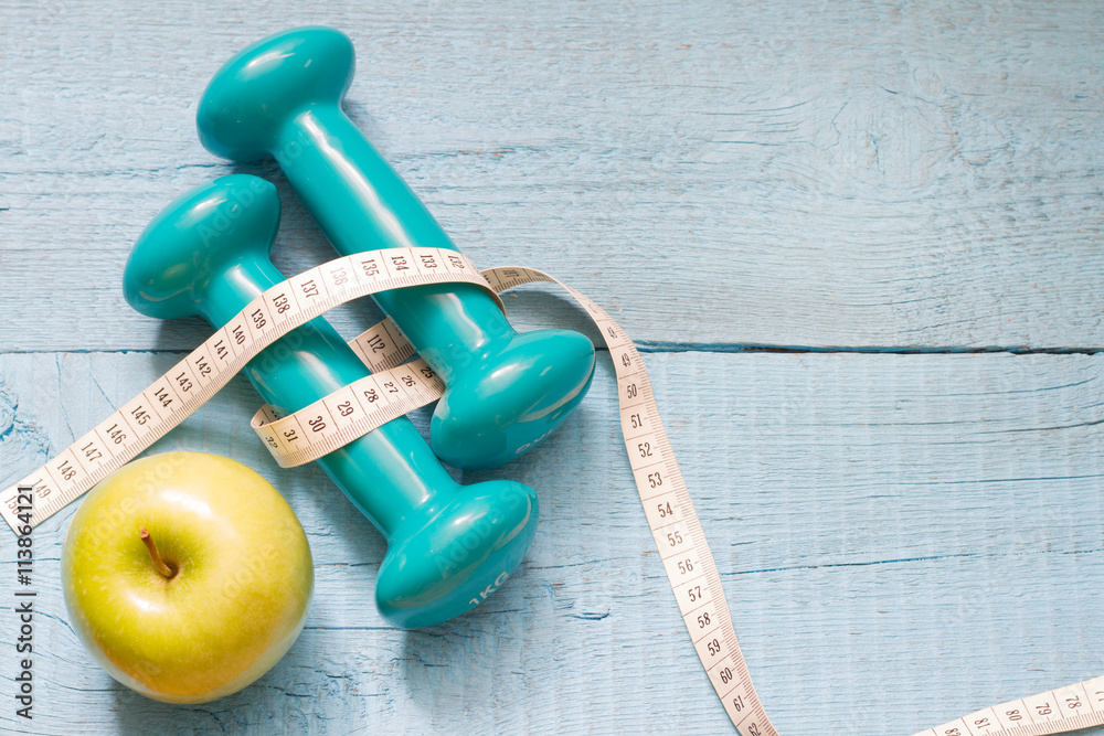 Fitness and diet abstract concept with dumbbells
Fitness and diet abstract concept with dumbbells