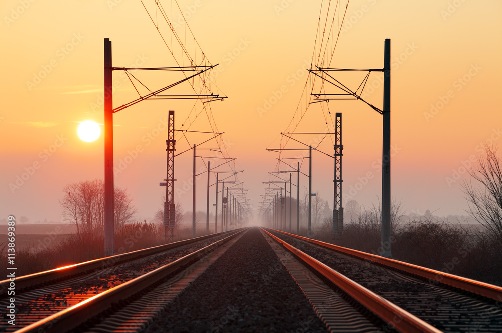 Railway at sunset with sun