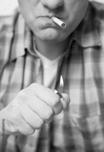 Photography Young man lighting a cigarette