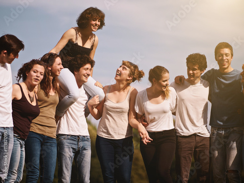 large group of friends tohether in a park having fun