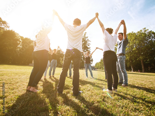 large group of friends tohether in a park having fun