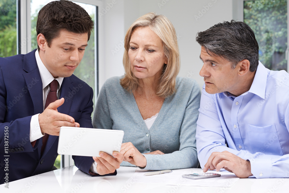 Mature Couple Meeting With Financial Advisor At Home Mature Couple Meeting With Financial Advisor At Home