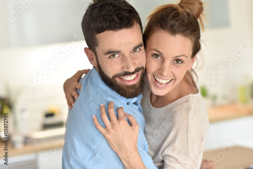 Cheerful hipster couple embracing each other © goodluz