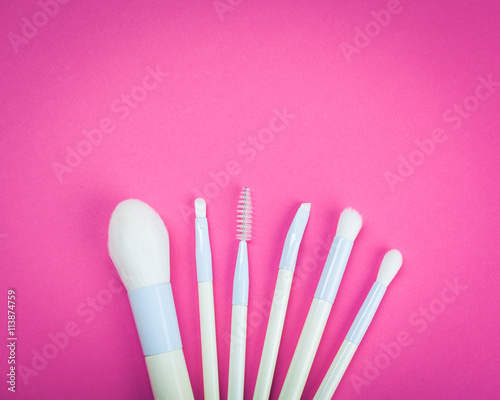 Set of colorful cosmetics on pink table