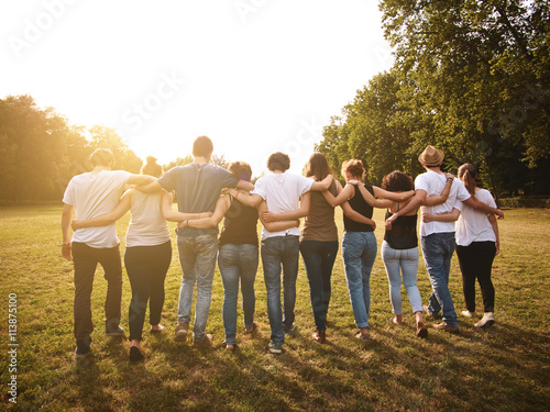 large group of friends together in a park having fun photo