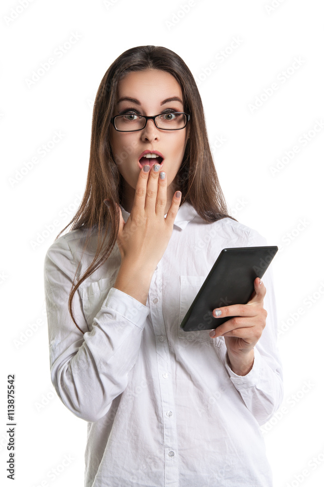 Beautiful young long-haired woman in glasses with an e-book. Human emotions, surprise, mouth open Beautiful young long-haired woman in glasses with an e-book. Human emotions, surprise, mouth open