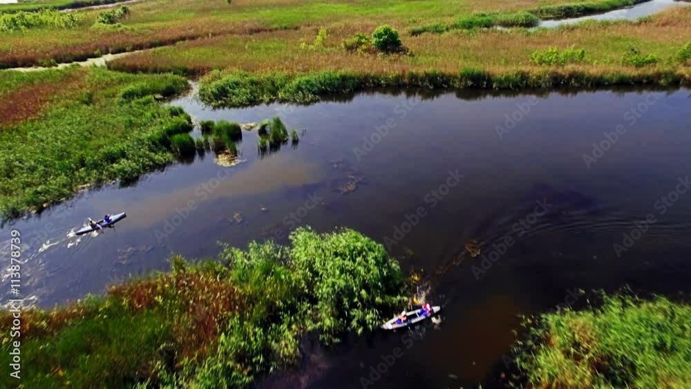 Kayaking on the river between the reeds Kayaking on the river between the reeds