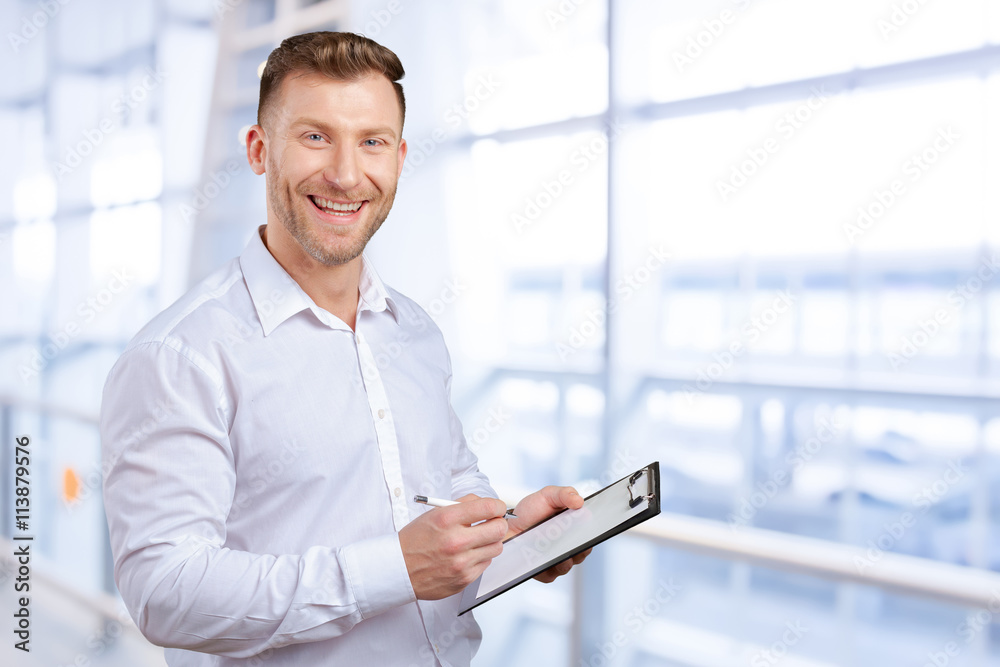 Portrait of young business man taking notes Portrait of young business man taking notes