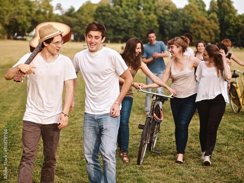 large group of friends together in a park having fun, back to school
