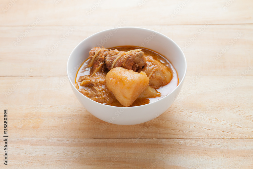 Chicken Mussaman Curry on wood table, Thai food Chicken Mussaman Curry on wood table, Thai food