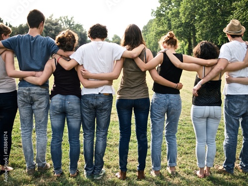 large group of friends together in a park having fun