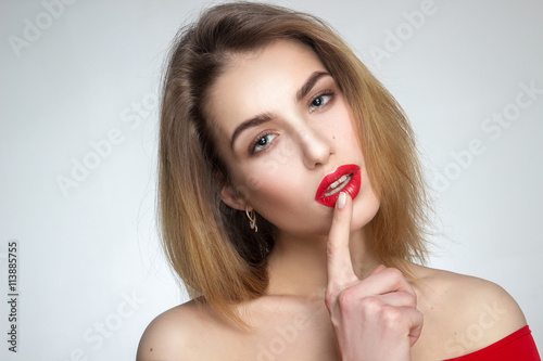 woman with red lips looking at the camera