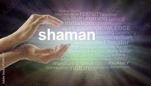 Shaman word cloud and healing hands - female cupped hands with the word SHAMAN between surrounded by word cloud on a graduated dark edged pink and green soft lit background