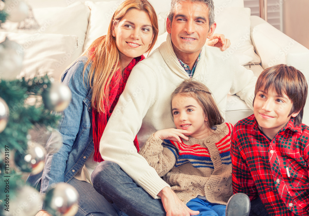 Happy family enjoying Christmas tree Happy family enjoying Christmas tree