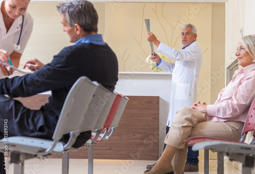 Doctors and patients in hospital waiting room