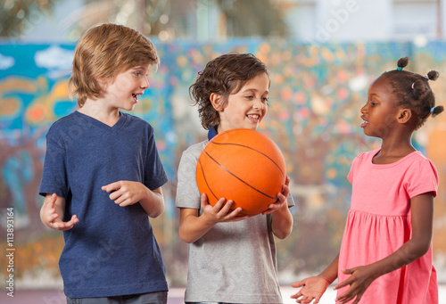 Smiling multi ethnic kids playing in schoolyard