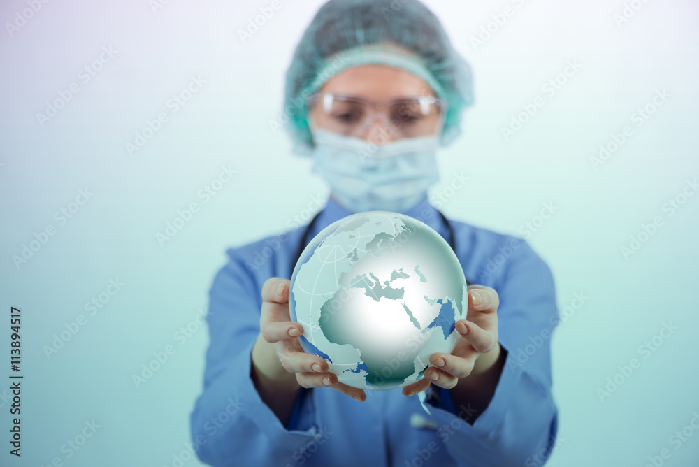 Woman doctor holding earth in globalisation concept Woman doctor holding earth in globalisation concept