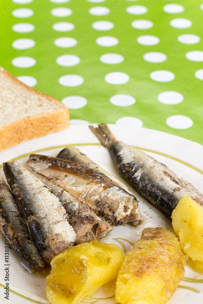 Marinated sardines served with potatoes and toast bread Marinated sardines served with potatoes and toast bread