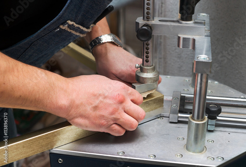Craftsman working on frame in frameshop.