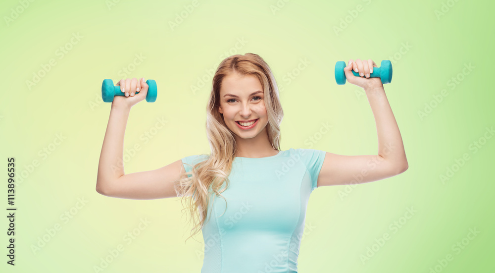 smiling beautiful young sporty woman with dumbbell smiling beautiful young sporty woman with dumbbell
