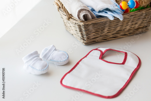 Bilde på lerret close up of baby bootees, bib and newborn stuff
