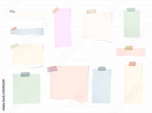 Torn colorful note paper pieces are stuck with sticky tapes on stripes background